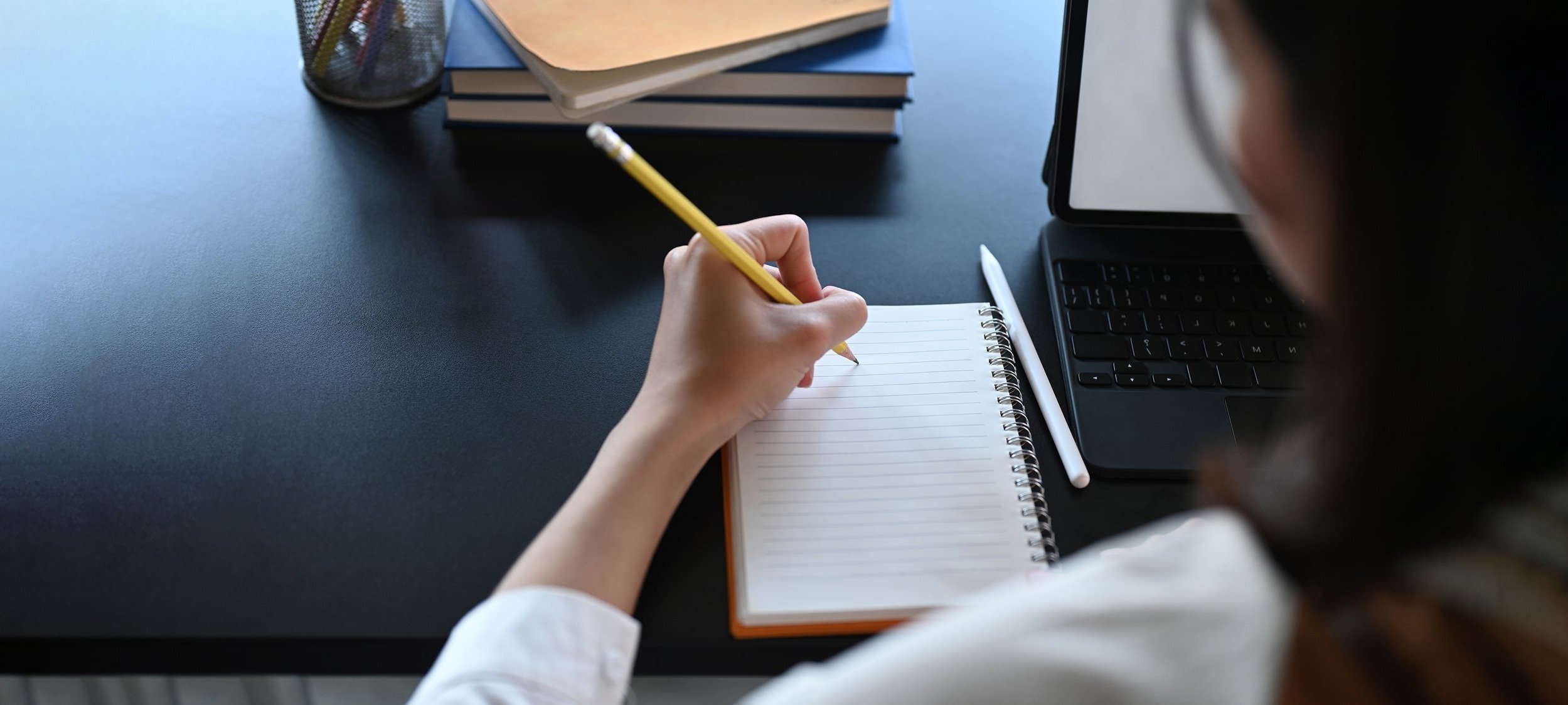 Girl writing on notepad